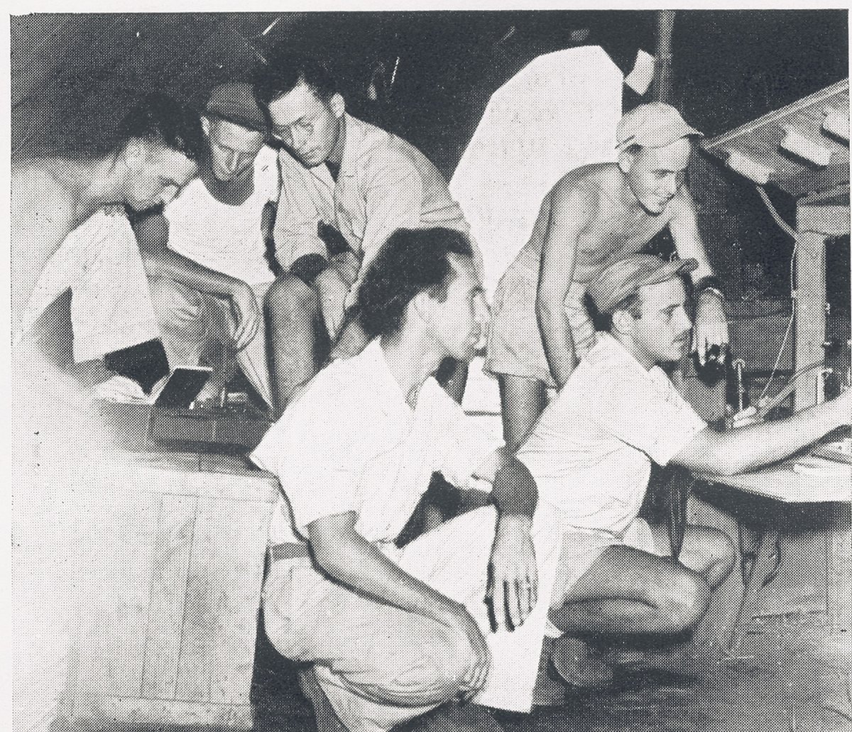 Another page from the same unit history book — that's Allen himself, turning the dials on the squadron's radio equipment. His own trade: Communication Chief.