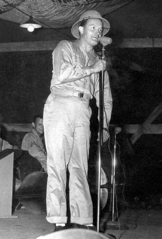 Taken by a squadron photographer, not by Allen: Bob Hope on stage, pith helmet and all, at the 90th Squadron's own Hollandia base. A squadron photographer, Jack, took it and five others of the same show (Frances Langford, Jerry Colonna, Patty Thomas, Judith Anderson) and shared them decades later on the 3rd Bomb Group's own history website — Allen's own unit, at a base he himself confirms landing at later in this interview. It isn't certain this is the very performance Allen attended, but it's the 90th Squadron's own Bob Hope show, photographed from the crowd he would have been standing in.Source: OzAtWar (Peter Dunn, ozatwar.com), photo courtesy of Jack, a 90th Squadron veteran.