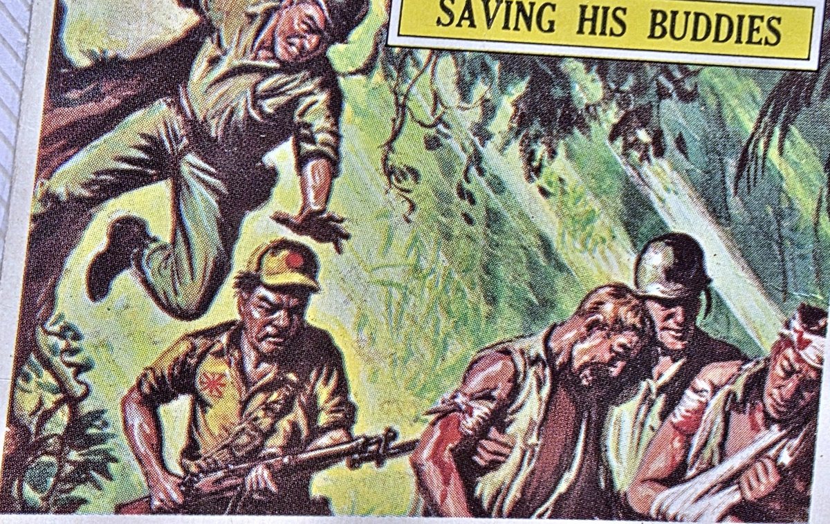 The front of card 34 of Topps&rsquo; &ldquo;Battle&rdquo; set, issued in 1965 &mdash; twenty years after the war, not during it: a painted jungle scene captioned "SAVING HIS BUDDIES" in a yellow banner at the top right. At the left a man plunges head-first from a tree, hands reaching down; at the centre a soldier in a peaked field cap marked with a red disc, a red sunburst on his sleeve, holds a bolt-action rifle across him; and at the right a bareheaded man and a man in a steel helmet sit propped together, with a further bandaged arm running off the right edge of the crop.
