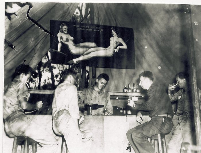 The squadron's makeshift club tent, decorated with hand-painted pin-up art typical of the era.