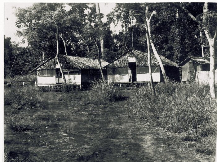 Jungle camp buildings, one signed “90th S.Q. Intelligence.”