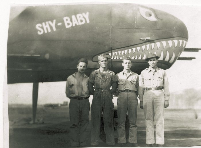 Four crewmen beneath “Shy-Baby.”