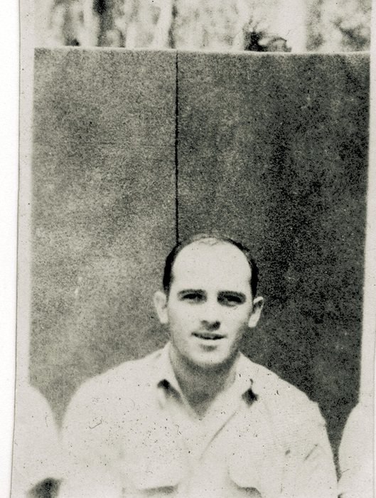 Allen, smiling, in a formal seated portrait.