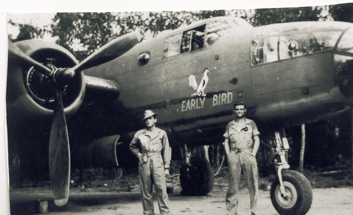 “Early Bird,” rooster nose art, two crewmen in front.