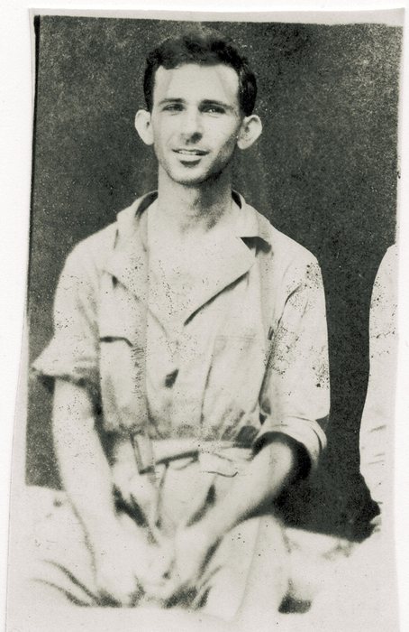A smiling seated serviceman.
