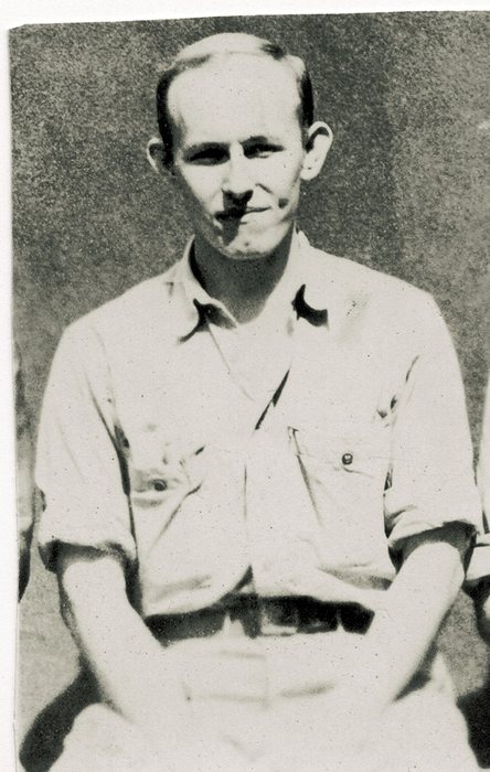 A seated, balding serviceman.