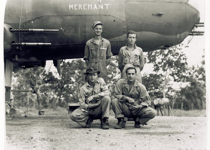 Four crewmen in front of “Merchant.”
