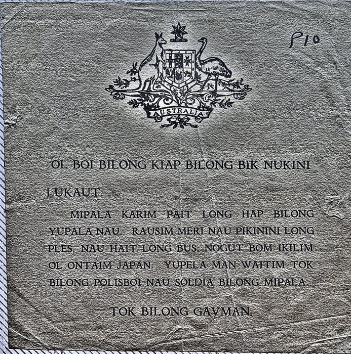 A leaflet printed in Tok Pisin beneath the Australian coat of arms, headed "OL BOI BILONG KIAP BILONG BIK NUKINI / LUKAUT." and continuing "MIPALA KARIM PAIT LONG HAP BILONG YUPALA NAU. RAUSIM MERI NAU PIKININI LONG PLES. NAU HAIT LONG BUS. NOGUT BOM IKILIM OL ONTAIM JAPAN. YUPELA MAN WAITIM TOK BILONG POLISBOI NAU SOLDIA BILONG MIPALA." and closing "TOK BILONG GAVMAN." -- a warning that the fighting is coming to the reader's area, to take the women and children out of the village and hide in the bush, and to wait for word from the government's police and soldiers; "P10" is pencilled at the upper right.