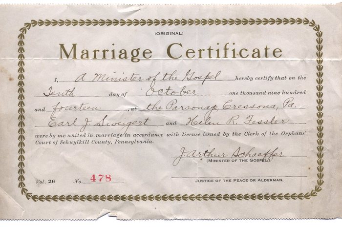 A printed "Marriage Certificate", folded and worn at the edges, recording that on the "Tenth" day of "October" "one thousand nine hundred and fourteen", at "the Parsonage, Cressona, Pa.", "Earl J. Sweigert" and "Helen R. Fessler" were married under a licence issued by the Clerk of the Orphans' Court of Schuylkill County, Pennsylvania. It is signed "J. Arthur Schaeffer", "Minister of the Gospel", and numbered "Vol. 26", "No. 478".